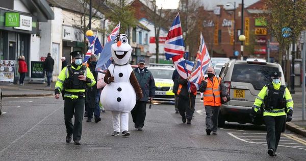 Flag protesters march in Belfast city centre to mark eighth anniversary of union flag dispute