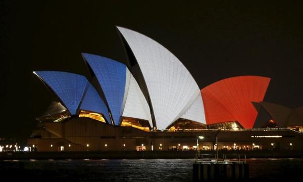 Sydney Opera House lit up in blue, white and red as…