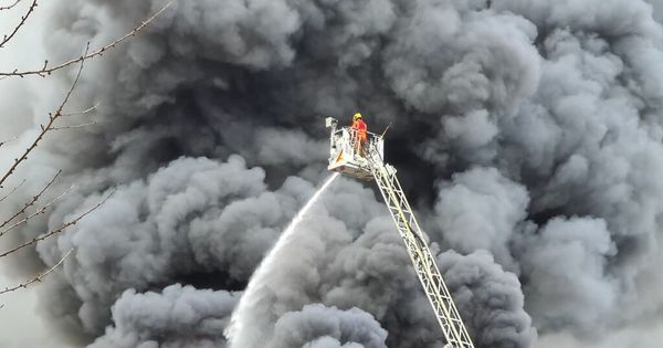 'You could feel the heat through the walls': Families tell of terrifying moment they were told to evacuate as huge fire raged just yards from their homes