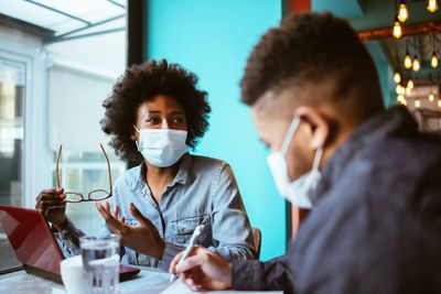 Should vaccinated people wear masks indoors?