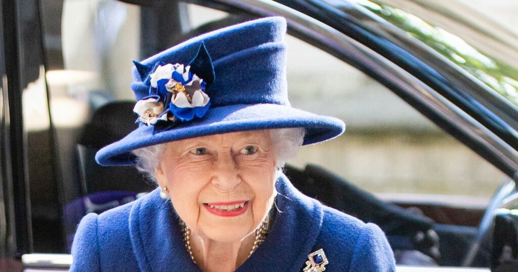 Queen uses a walking stick as she arrives at…