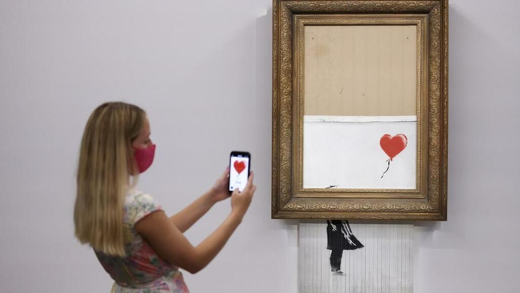 Banksy painting that shredded itself at auction sells…
