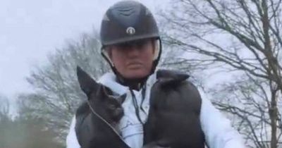 Katie Price risks jail as she carries her new puppy while horse riding