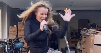 Amanda Holden gives garage performance in black latex boots