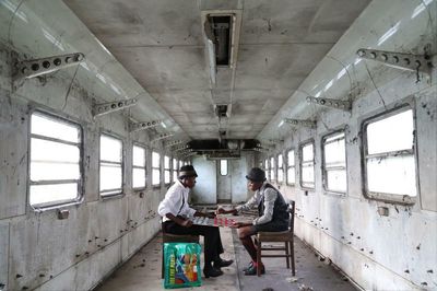 Two men playing draughts on an abandoned train: Gosette Lubondo’s best photograph