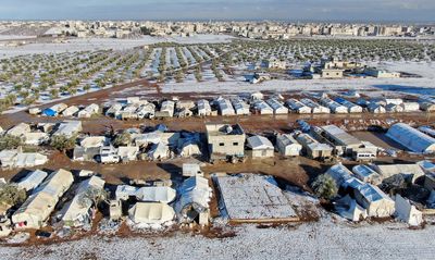 Storm blankets Syrian tented camps in snow, at least one child dead
