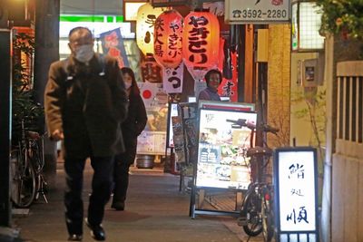 Japan widens virus restrictions as omicron surges in cities