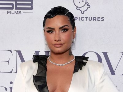 Demi Lovato holds ‘funeral’ for pop music and teases new era in photo with Scooter Braun
