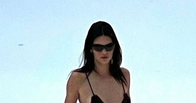 Kendall Jenner stomps through the snow in a tiny bikini while enjoying chilly ski trip