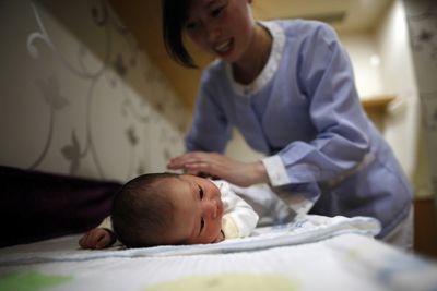 As Chinese shun parenthood, firms dangle bonuses, loans and leave