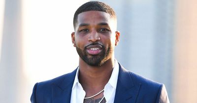 Tristan Thompson seen with mystery woman sitting on his lap after fathering third child