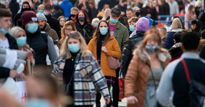 Covid briefing: Cases in Wales plummet and shoppers in England still asked to wear mask despite law change
