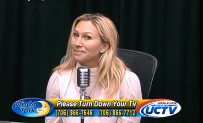 Marjorie Taylor Greene smiles awkwardly as caller says she is ‘an embarrassment to the state of Georgia’
