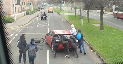 Kind-hearted Edinburgh schoolboys help push broken down car out of road