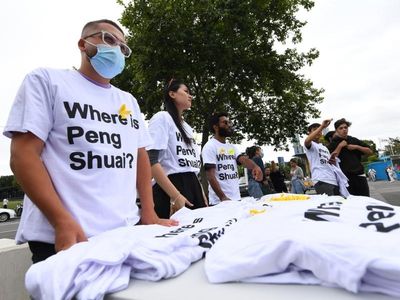 Peng supporters hand out T-shirts at Open