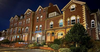 Abandoned mental health centre where mattresses lie on the floor in secure rooms