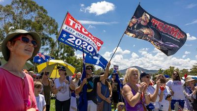 Anti-vaxxers gather at Parliament House holding Trump signs