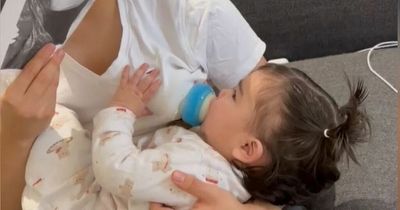 Dad uses mask of his wife to get baby to drink from the bottle