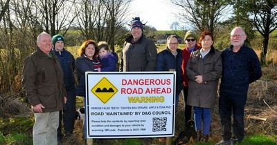 Furious Scottish residents put up warning signs at pothole plagued road