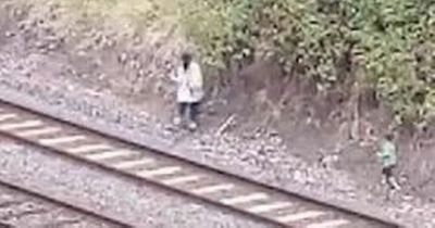 Nail biting clip shows mum and child 'picking blackberries' next to train tracks