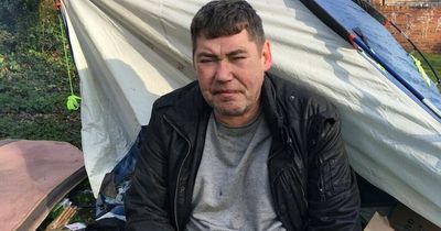 Homeless man living in a tent burns his own clothes to stay warm outdoors