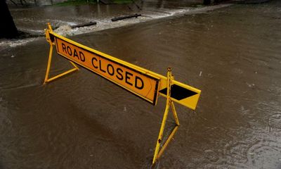 Monsoon system wreaking havoc across Australia leaves towns cut off and roads flooded