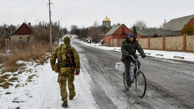 Life in Ukraine's 'grey zone' goes on as troops mass on its borders