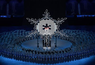 Olympics-Opening ceremony ends with Uyghur skier lighting cauldron