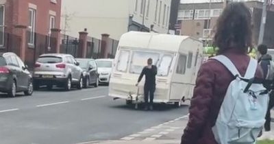 Bizarre moment man wheels caravan through the street in Leeds