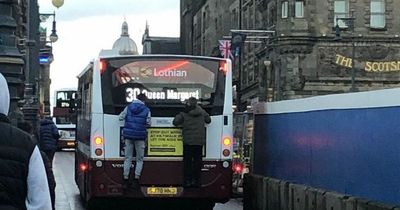 Teens caught dangerously hanging from back of Edinburgh bus on busy road