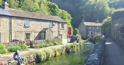 The stunning peakland village near Greater Manchester that boasts its own caves and a castle