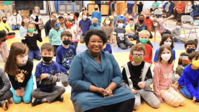 Why Is Stacey Abrams the Only Unmasked Person in This Photo?