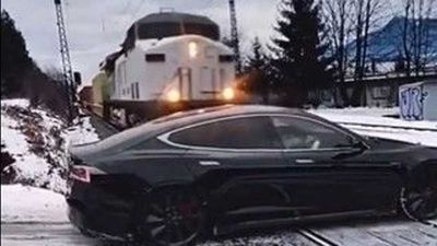 Watch Tesla Get Run Over By Train And Drive Away: There's A Catch