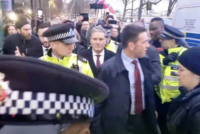 Keir Starmer bundled into police car after being swarmed by protesters shouting abuse and Savile slurs