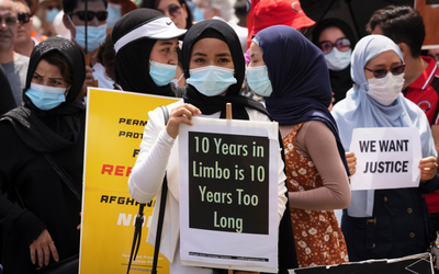 Afghan refugees march on Parliament House to reunite their families and end their state of limbo