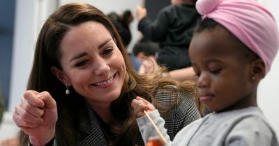 Beaming Kate Middleton gets stuck in as she plays with toddlers during cooking workshop