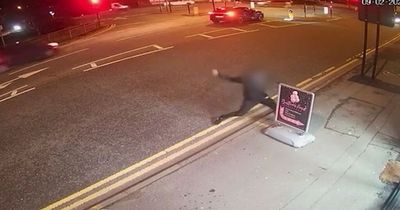 Man seen fighting with shop sign in bizarre CCTV footage