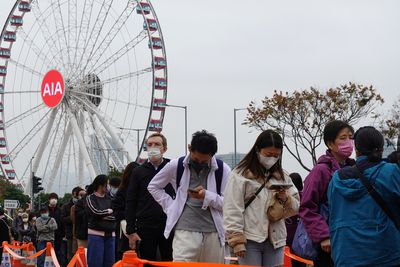 Record Hong Kong COVID infections strain hospitals, China pledges support