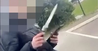 Schoolboy pulls out huge blade from his waistband in appalling footage