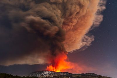 Volcanic lightning streaks sky over fiery Mount Etna