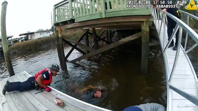 VIDEO: Cops Jump In Freezing River To Rescue Drowning Woman Trapped Under Dock