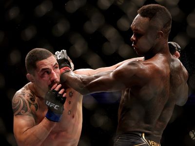 Israel Adesanya overcomes rival Robert Whittaker again with narrow decision win at UFC 271