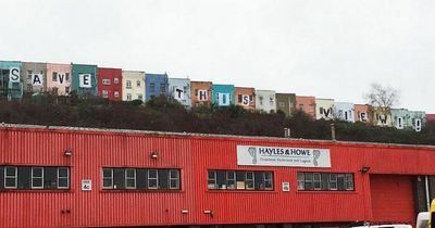Totterdown residents hang bedsheets from iconic coloured houses in protest over new flats