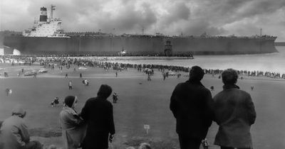 A Tyneside-built supertanker leaves the River Tyne as thousands look on