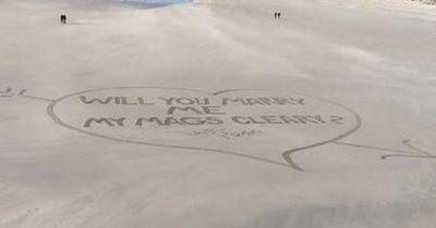 Boyfriend carves out giant wedding proposal at beach on Valentine's Day