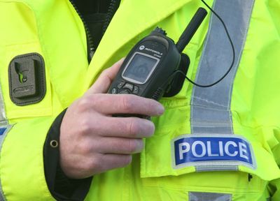 Two people charged after man found dead in flat