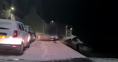 Nail-biting moment car drives down narrow snowy road on Scots seafront during storm