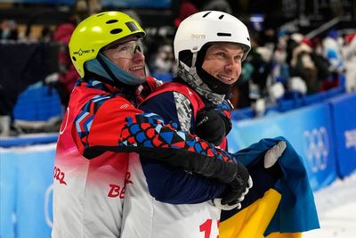Ukrainian and Russian celebrate with hug at Beijing Olympics