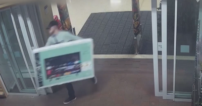 CCTV catches man casually walking out of Tesco with a 50inch TV