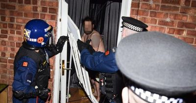 'You're famous': Shirtless man's door smashed down as cops storm homes and make dozens of arrests